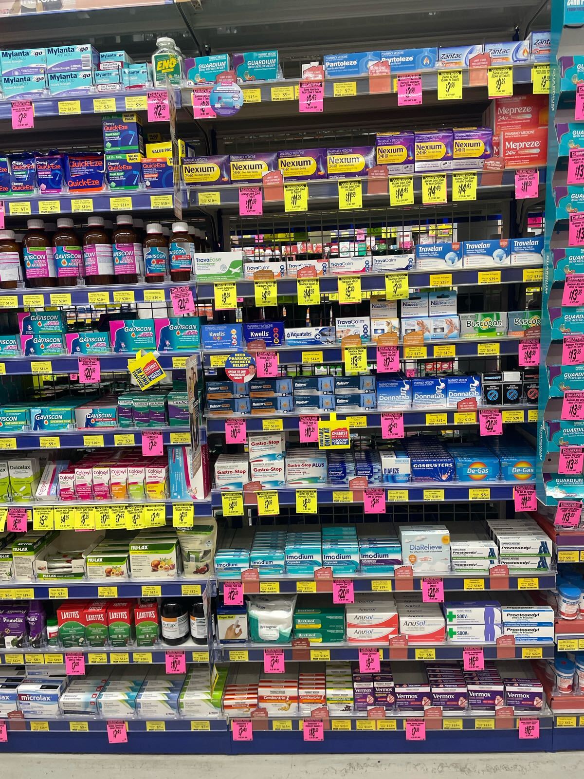 Digestive health shelves showing product facings and promotional tickets in a pharmacy
